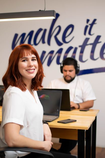 Woman smiling while she works at coworking space